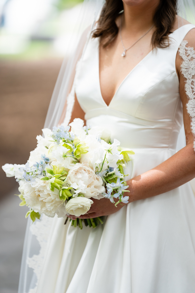Bridal portrait of Hannah surrounded by lush greenery at the Dallas Arboretum