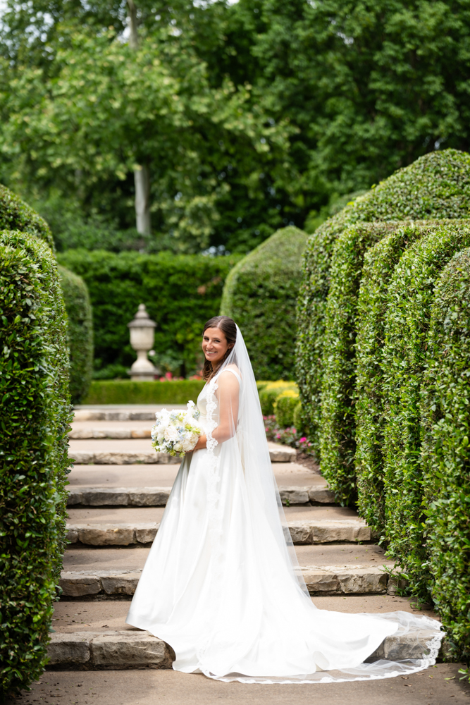 Hannah in her wedding gown among the gardens at the Dallas Arboretum