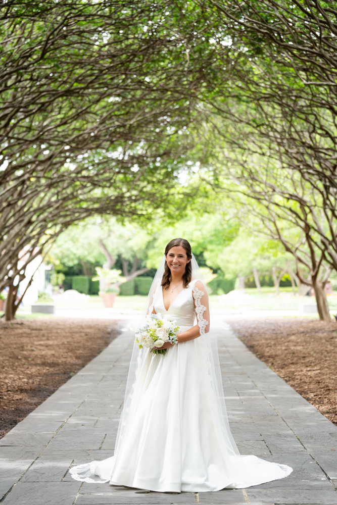 Hannah in her wedding gown among the gardens at the Dallas Arboretum