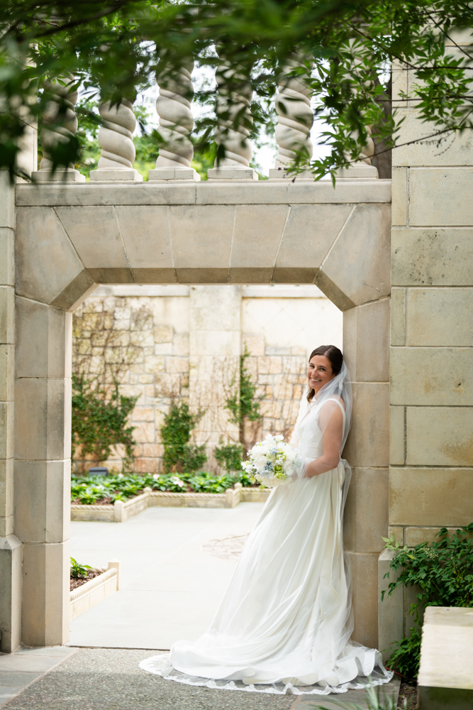 Hannah walking through the blooms at the Dallas Arboretum in her wedding dress