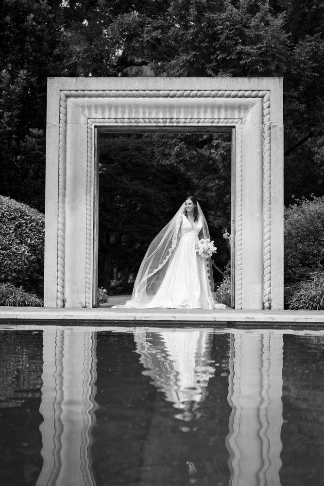 Elegant bridal portrait of Hannah framed by garden foliage in Dallas