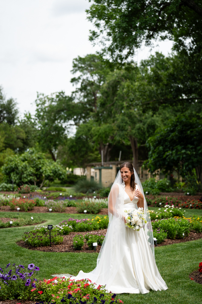 Detail of Hannah's gown and bouquet in the soft garden light