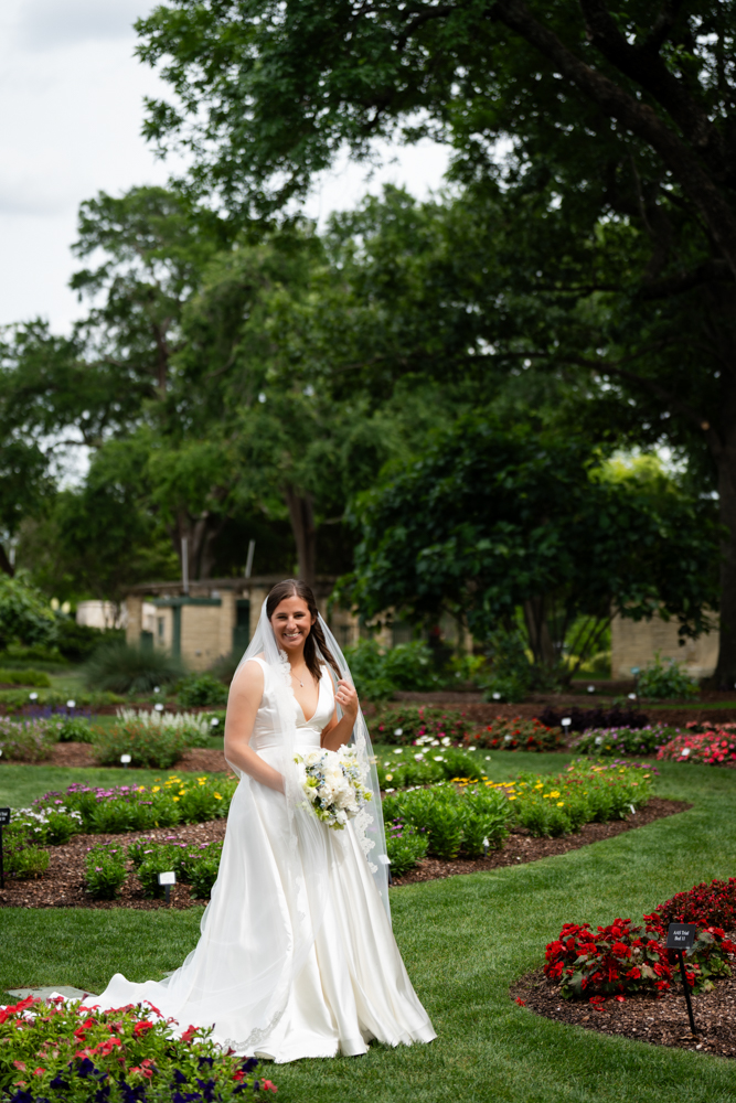 Hannah among the greenery of the Dallas Arboretum before her Dallas wedding