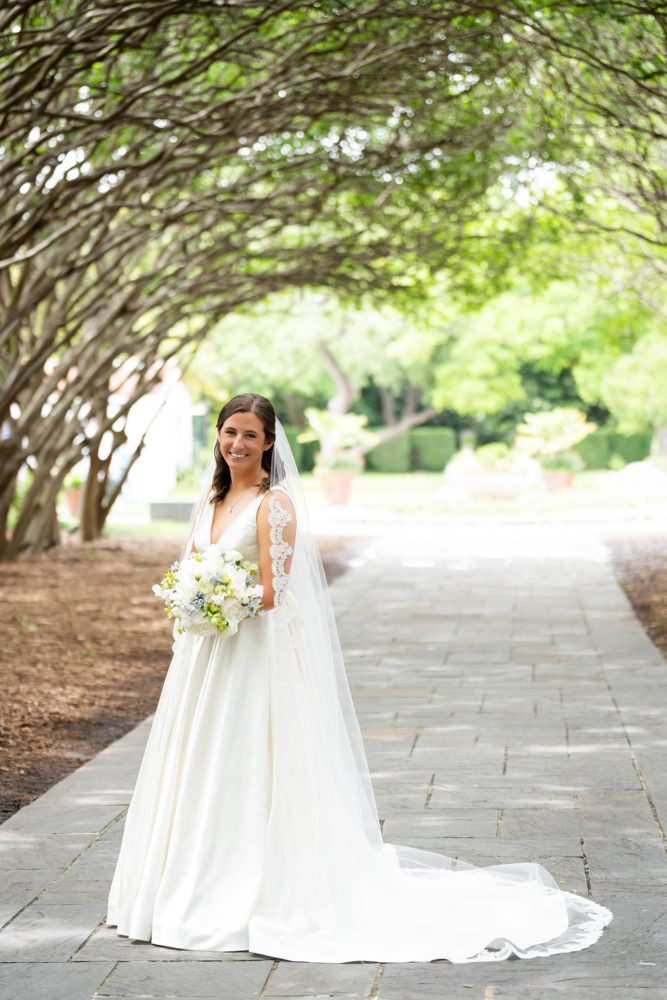 Full-length bridal portrait of Hannah at the Dallas Arboretum in Dallas
