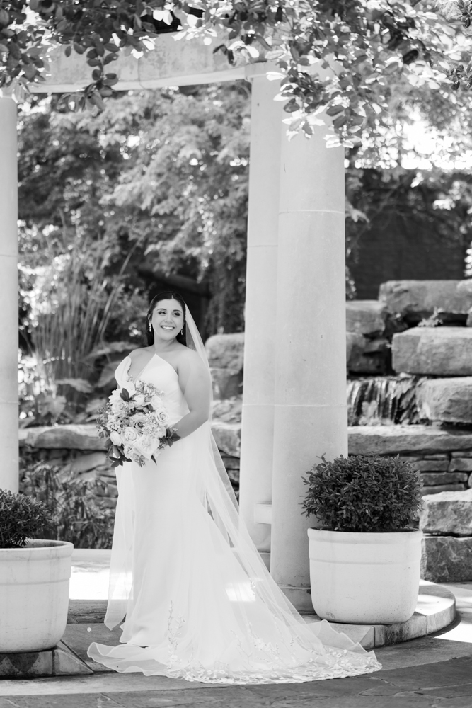 Caroline in her wedding gown among the greenery of the Fort Worth Botanic Garden