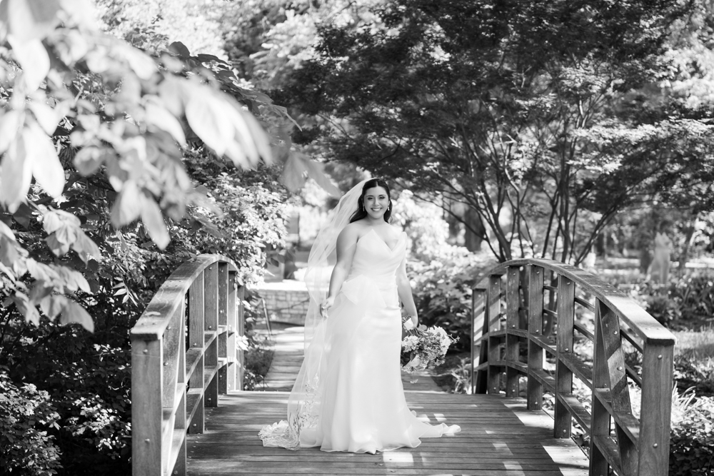 Caroline in her wedding gown among the greenery of the Fort Worth Botanic Garden