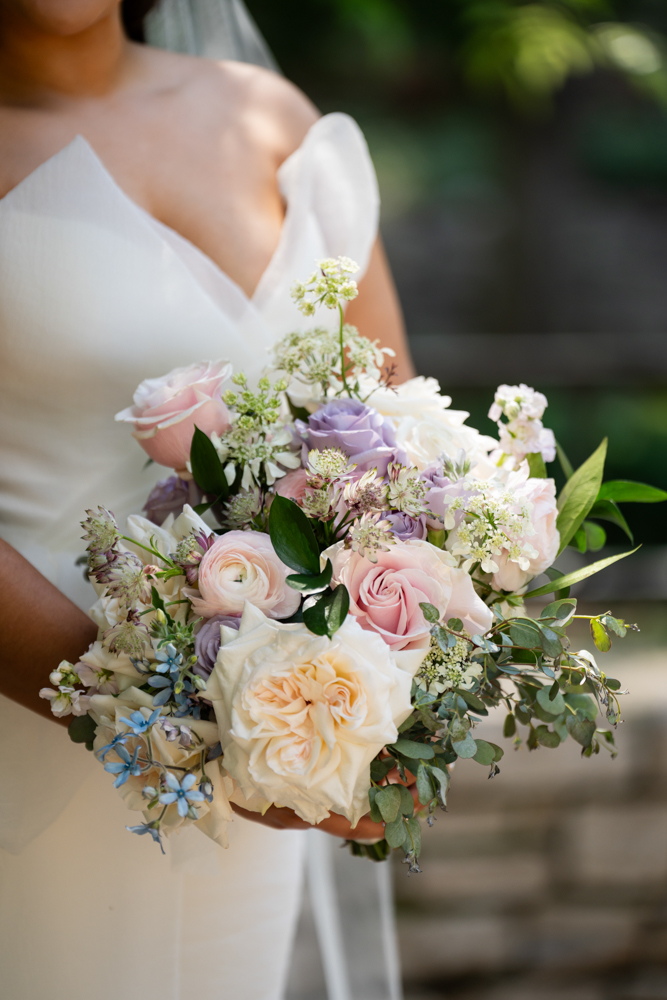 Caroline holding her TWE Floral bouquet at the Fort Worth Botanic Garden