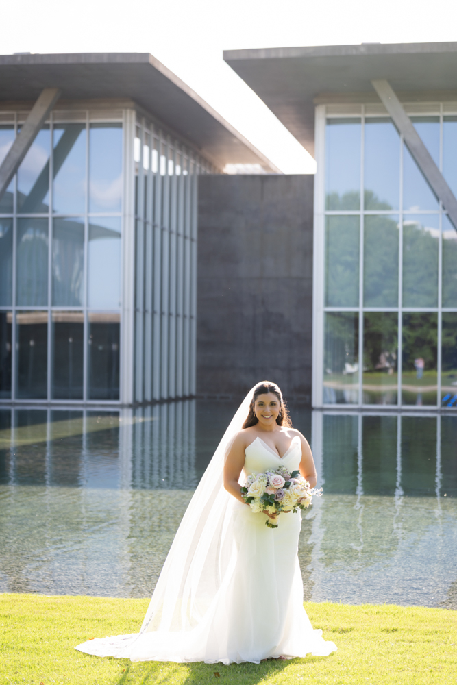 Caroline in her wedding gown among the greenery of the Fort Worth Botanic Garden