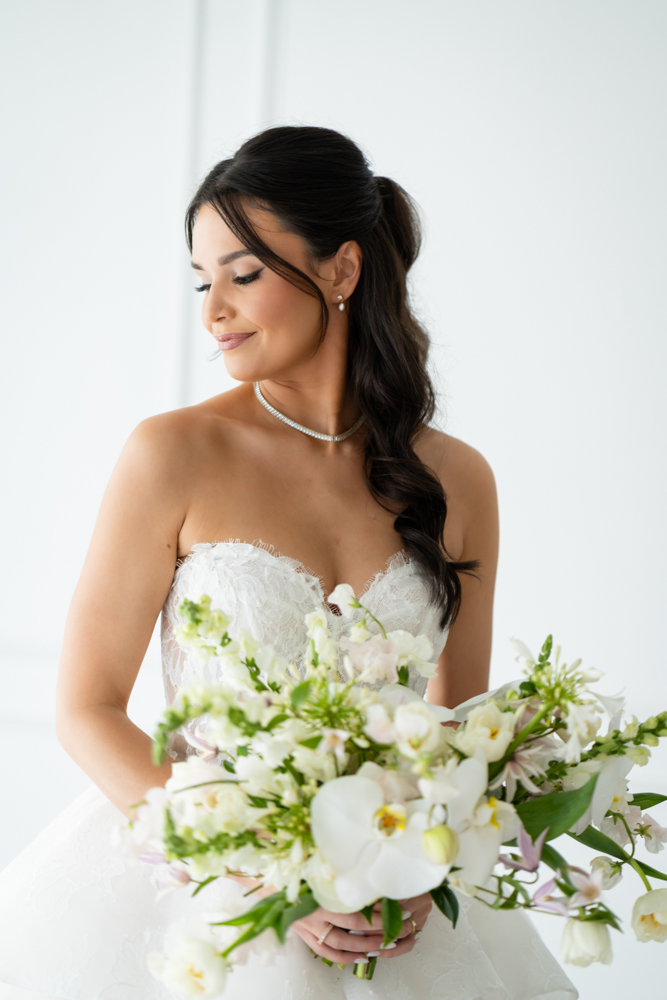 Hannah standing tall in her gown, the drapery gently framing the scene