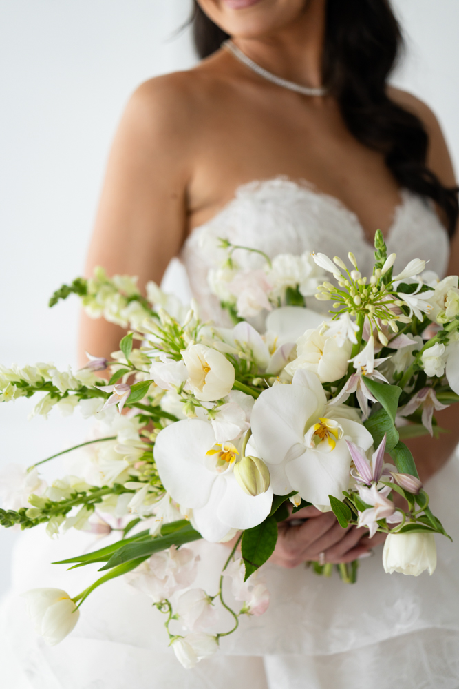 A quiet, intentional bridal pose with light shaping Hannah's face and gown
