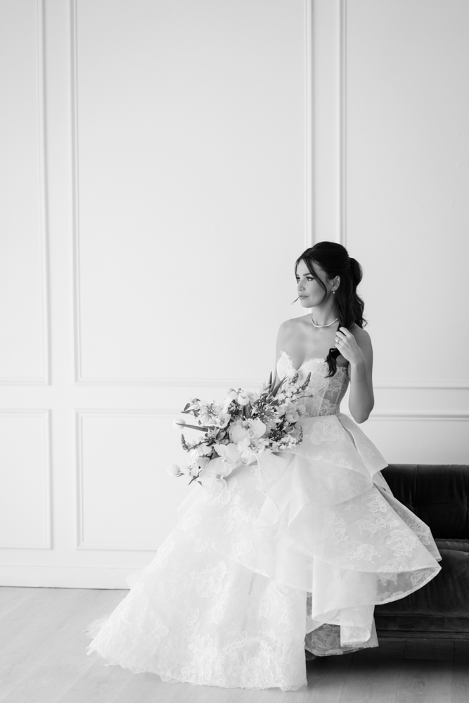 The custom drapery archway curving behind Hannah during her bridal session