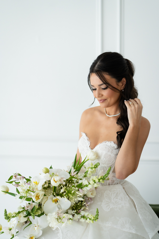 Bridal portrait of Hannah with her bouquet, clean studio lines all around