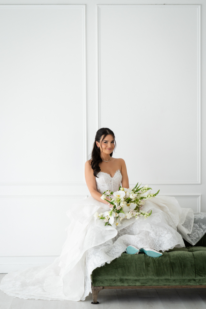 Hannah's hands resting against the skirt of her wedding gown