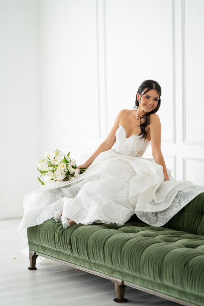 Full-length bridal portrait of Hannah, her gown pooling softly on the studio floor