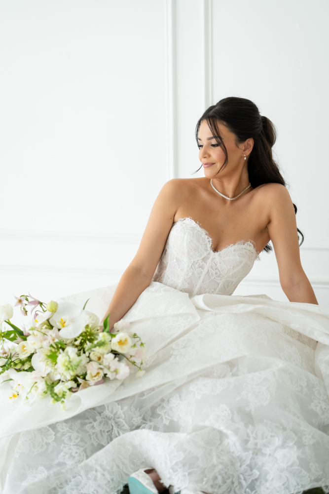 Close-up of the bodice and beadwork of Hannah's wedding gown in soft studio light