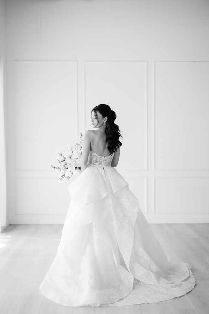 Hannah looking over her shoulder, the back of her gown catching the light