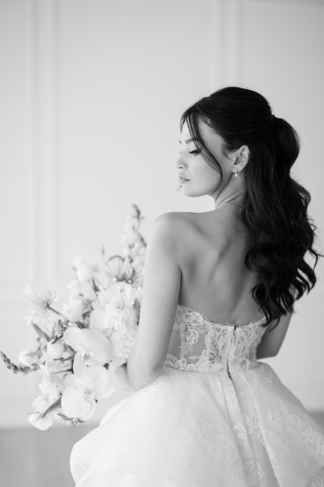Seated bridal portrait of Hannah against a simple, uncluttered studio background