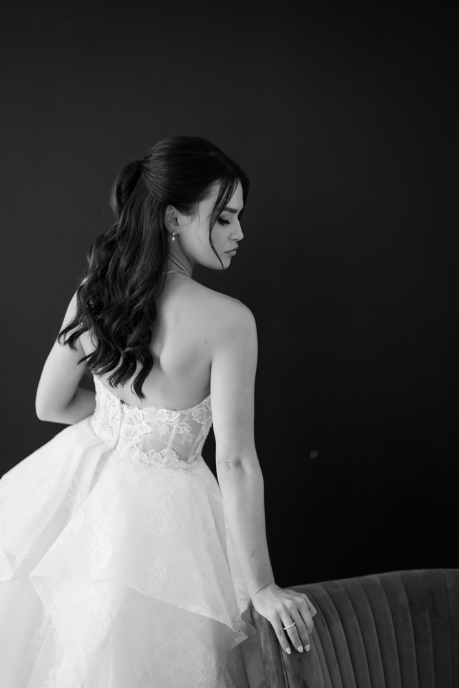 Hannah standing tall in her gown, the drapery gently framing the scene