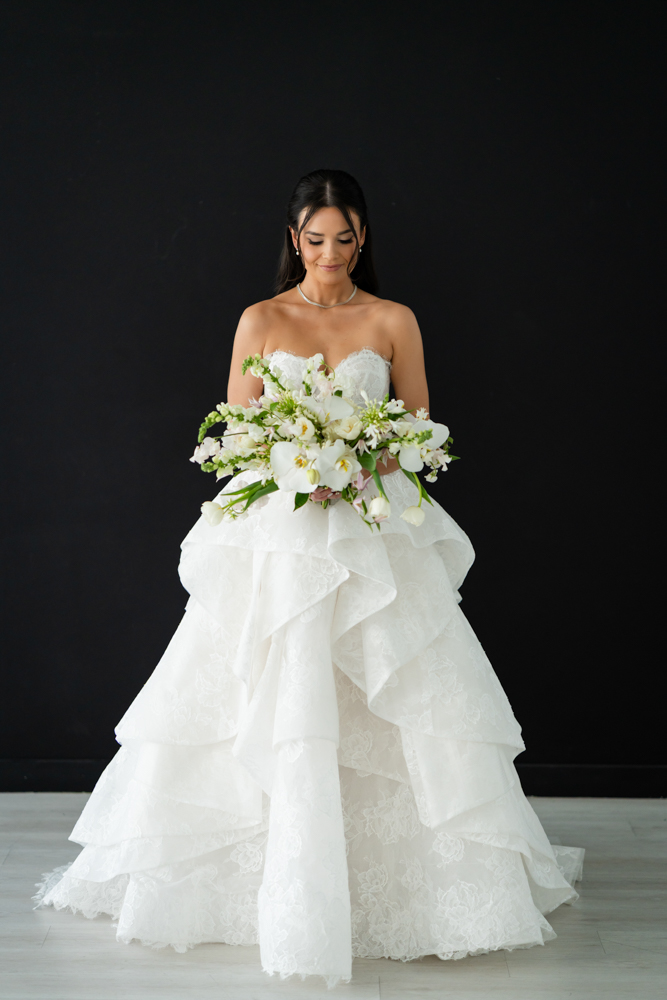 Hannah's gown and train arranged in graceful folds on the studio floor