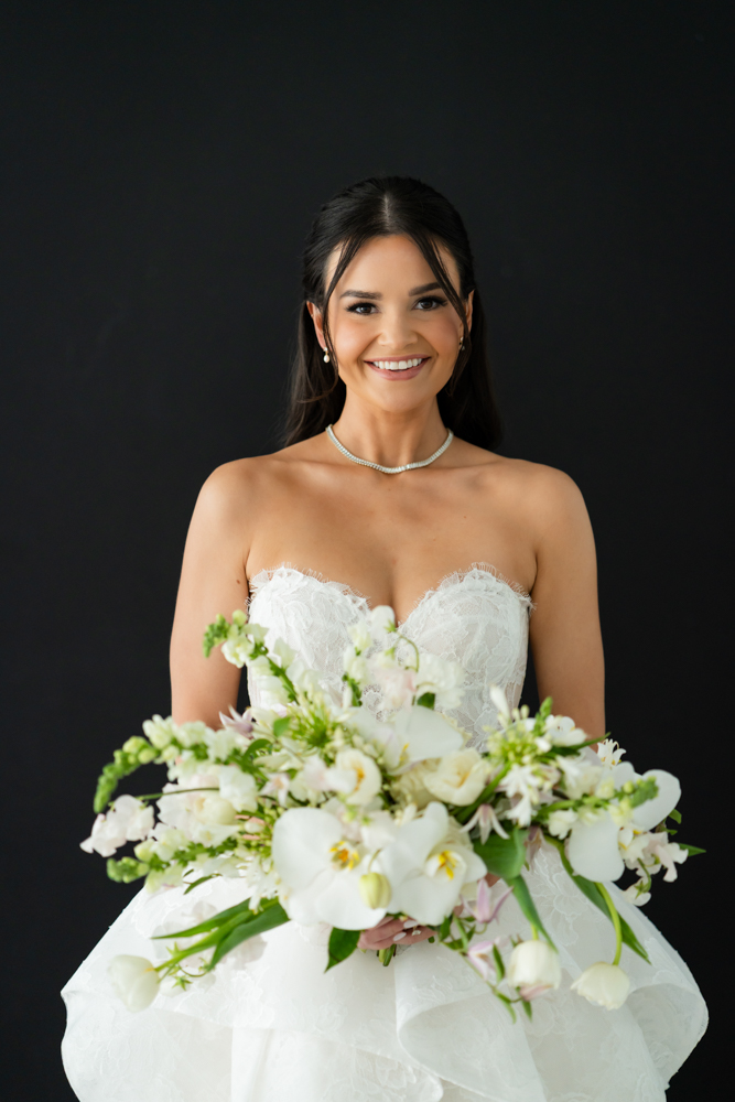 A quiet, intentional bridal pose with light shaping Hannah's face and gown