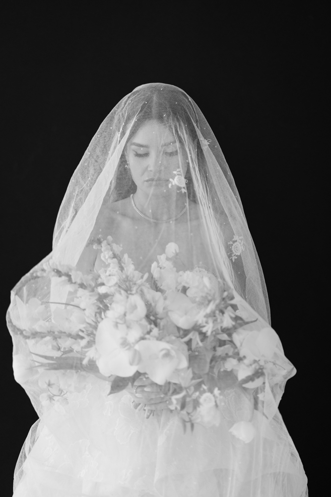 The custom drapery archway curving behind Hannah during her bridal session