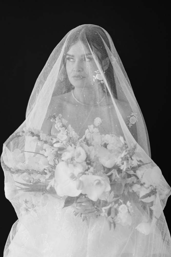 Bridal portrait of Hannah with her bouquet, clean studio lines all around