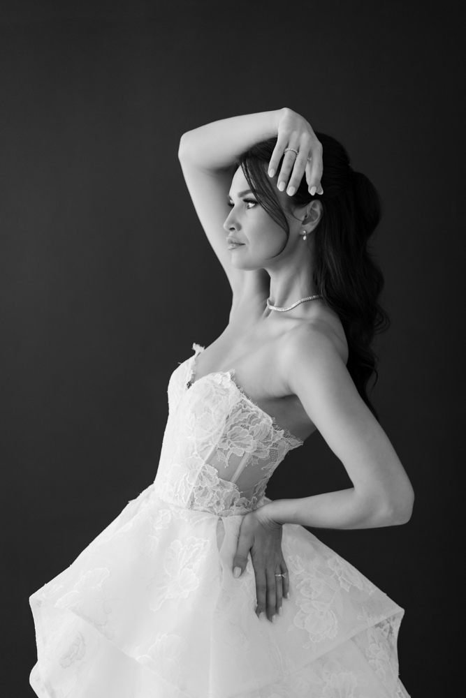 Side profile of Hannah in her gown, soft studio light tracing the fabric