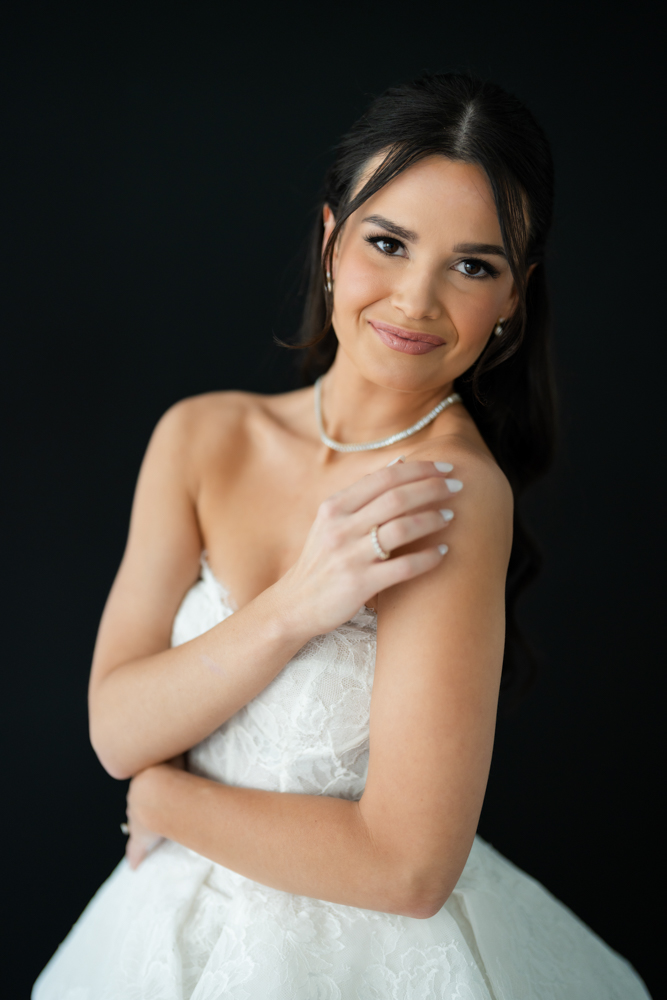 Bride Hannah in her wedding gown against a clean studio backdrop at The Lumen Room in Fort Worth