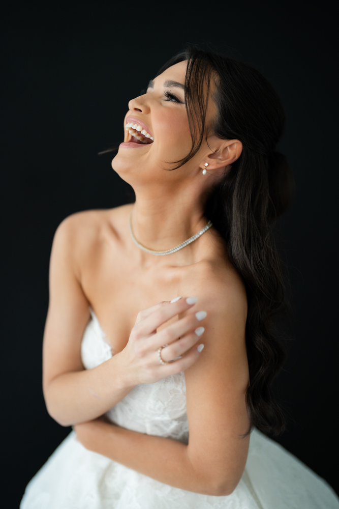 Full-length bridal portrait of Hannah, her gown pooling softly on the studio floor