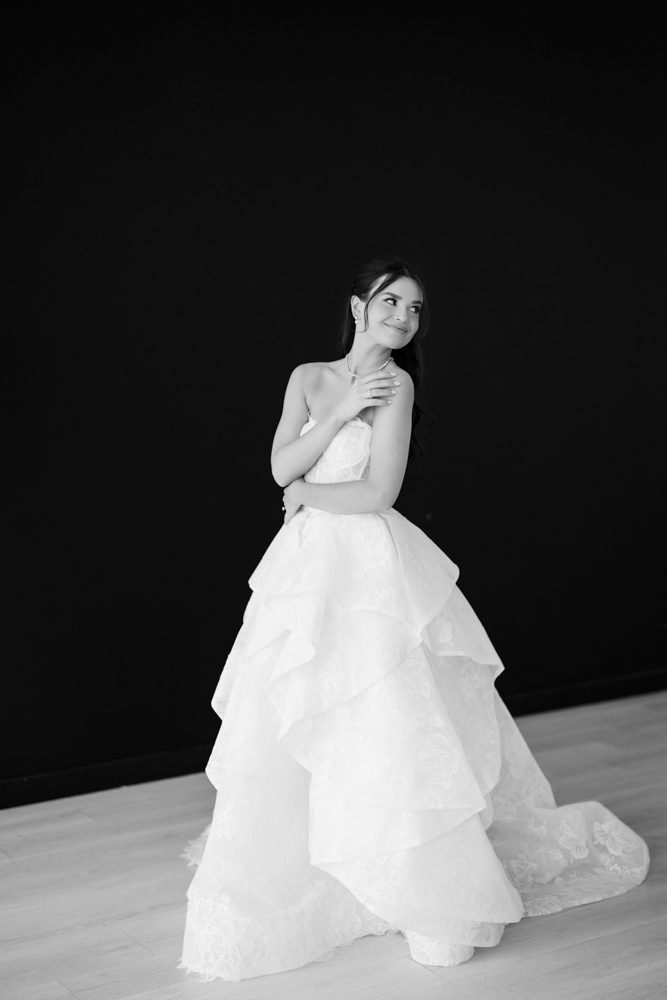 Hannah framed by the soft drapery archway custom-built for her bridal session