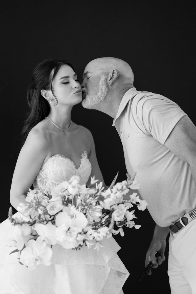 Hannah holding her bouquet as soft light falls across her gown