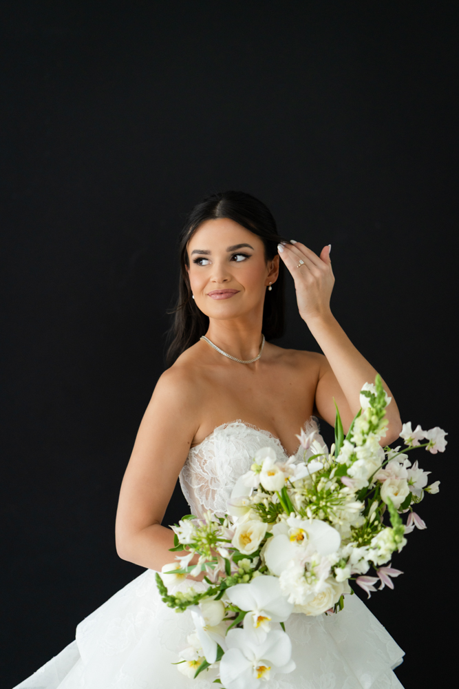 Portrait of Hannah beneath the false archway and draped fabric in the Fort Worth studio