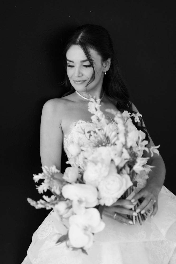 A quiet, intentional bridal pose with light shaping Hannah's face and gown