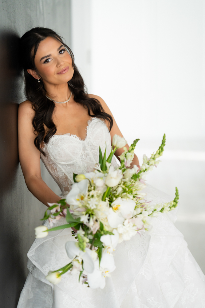 The custom drapery archway curving behind Hannah during her bridal session