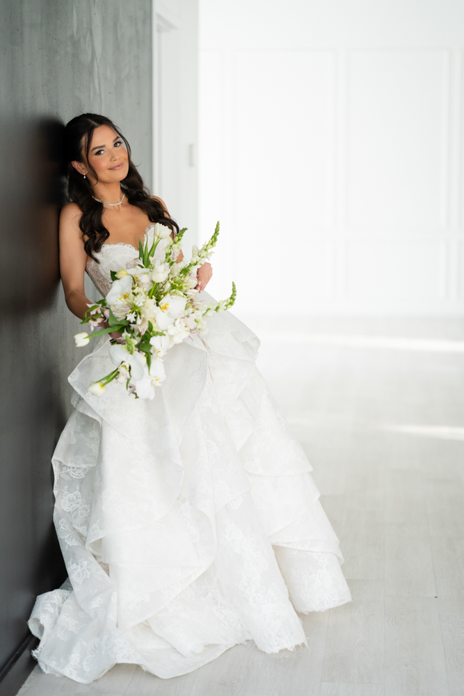 Side profile of Hannah in her gown, soft studio light tracing the fabric