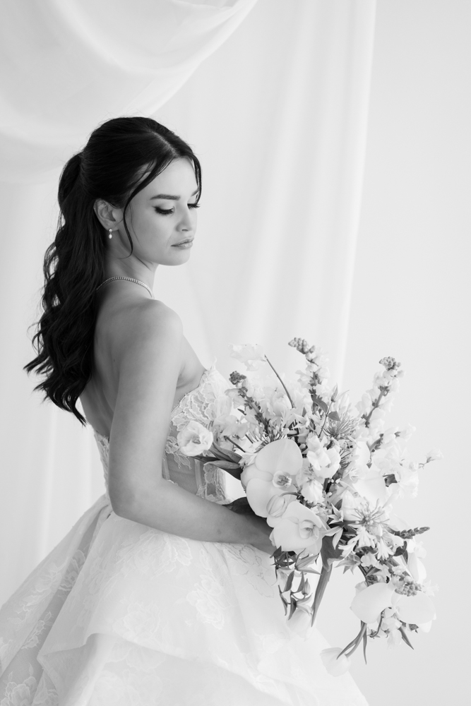 Bride Hannah framed by soft fabric and light in the Fort Worth studio