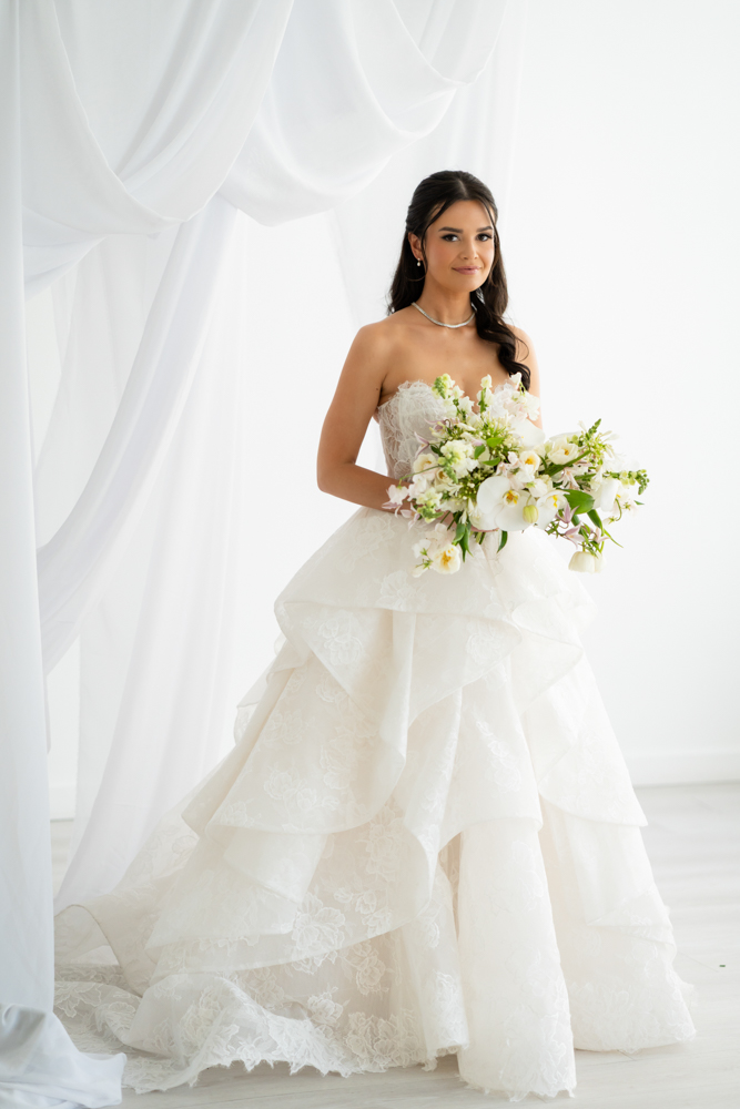 Hannah framed by the soft drapery archway custom-built for her bridal session