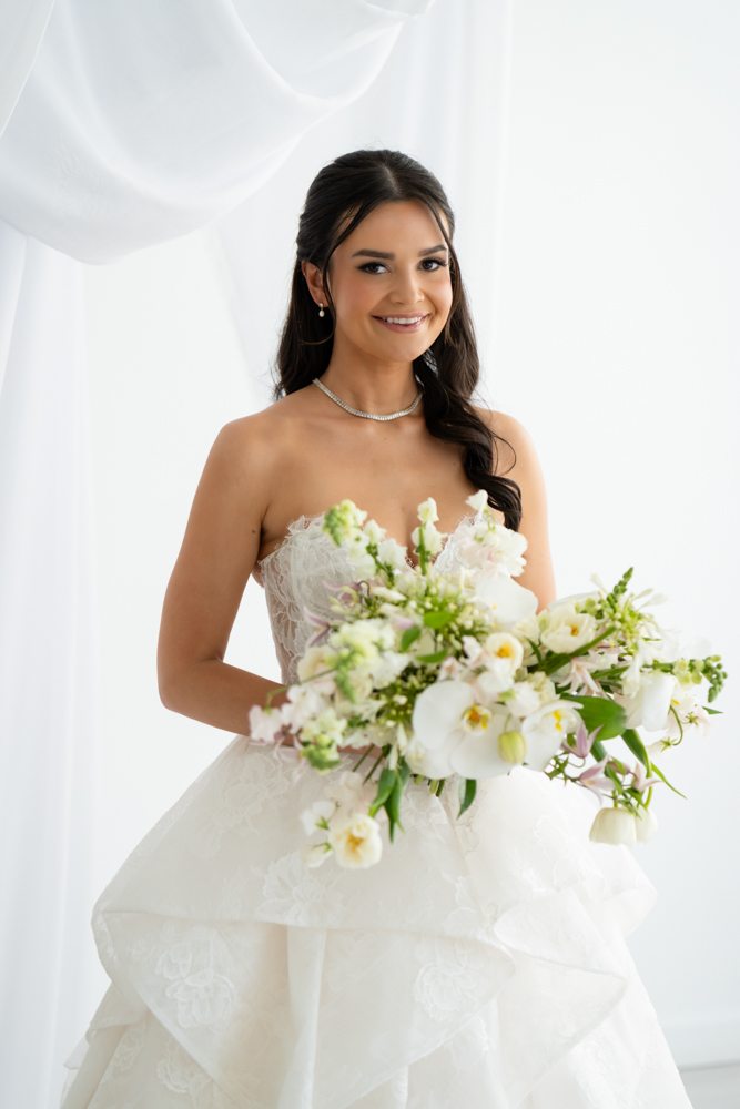 Close-up of the bodice and beadwork of Hannah's wedding gown in soft studio light
