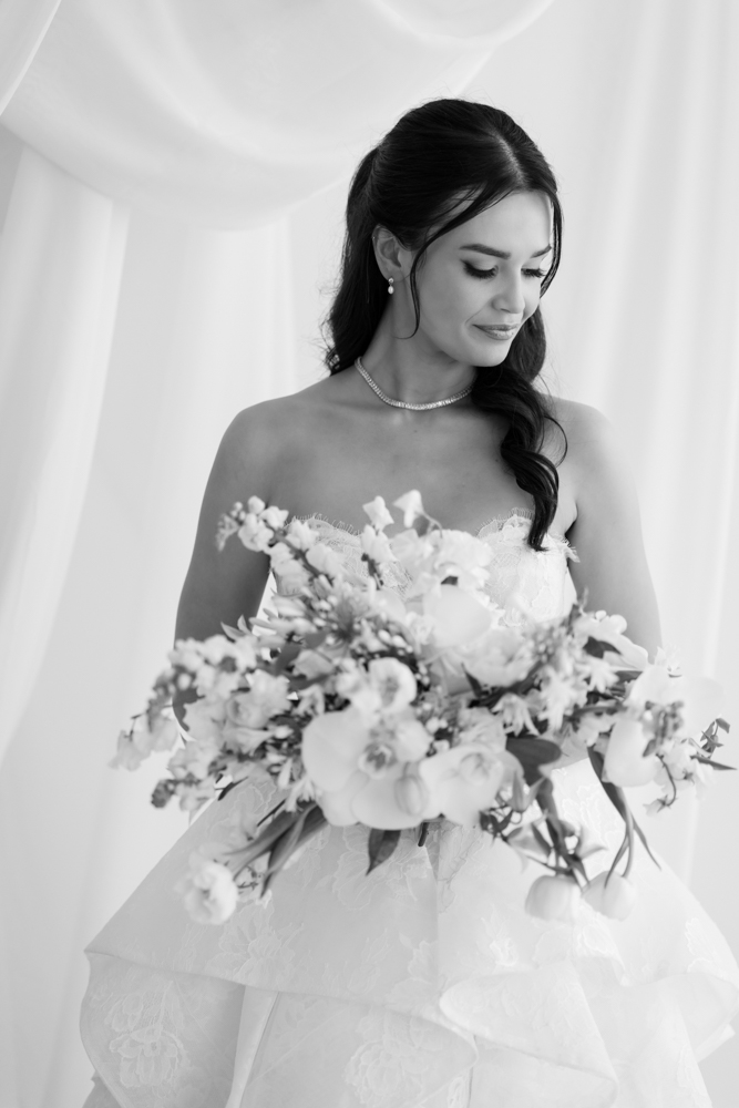 Hannah looking over her shoulder, the back of her gown catching the light
