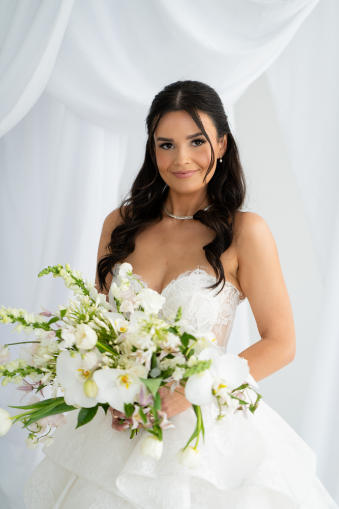 Portrait of Hannah beneath the false archway and draped fabric in the Fort Worth studio