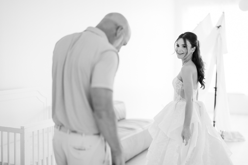 Hannah holding her bouquet as soft light falls across her gown