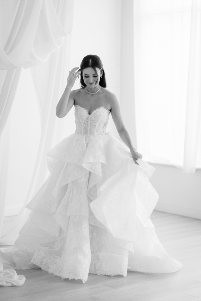 Hannah's gown and train arranged in graceful folds on the studio floor