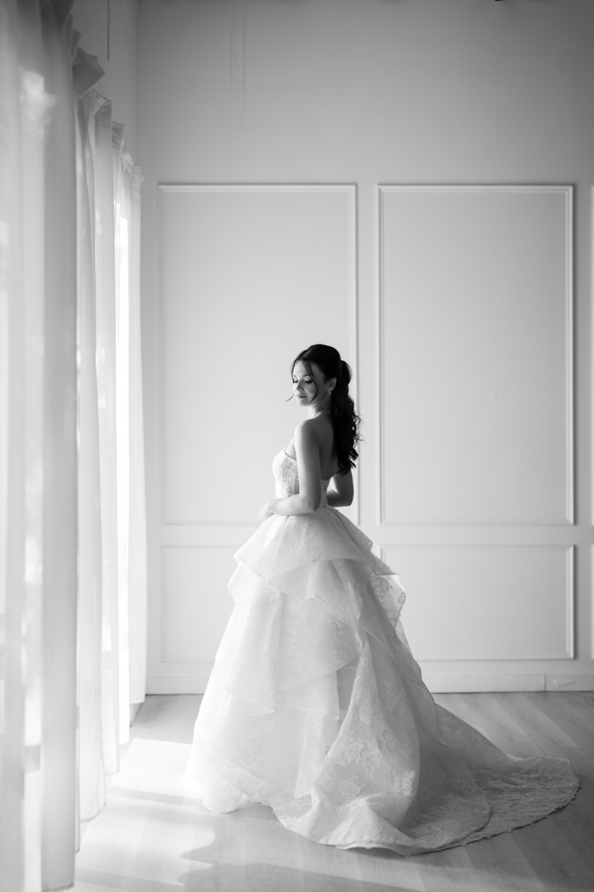 The custom drapery archway curving behind Hannah during her bridal session