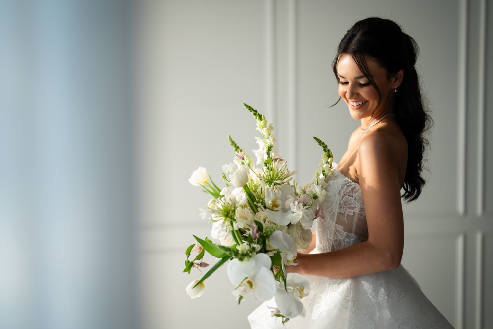 Side profile of Hannah in her gown, soft studio light tracing the fabric
