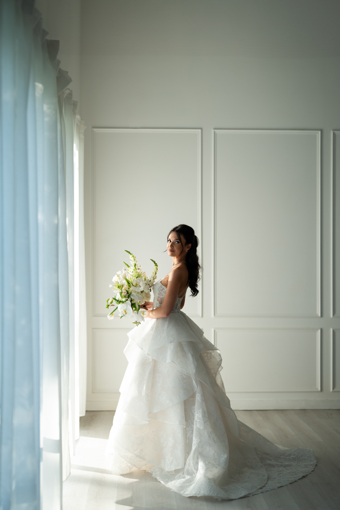 Bride Hannah in her wedding gown against a clean studio backdrop at The Lumen Room in Fort Worth
