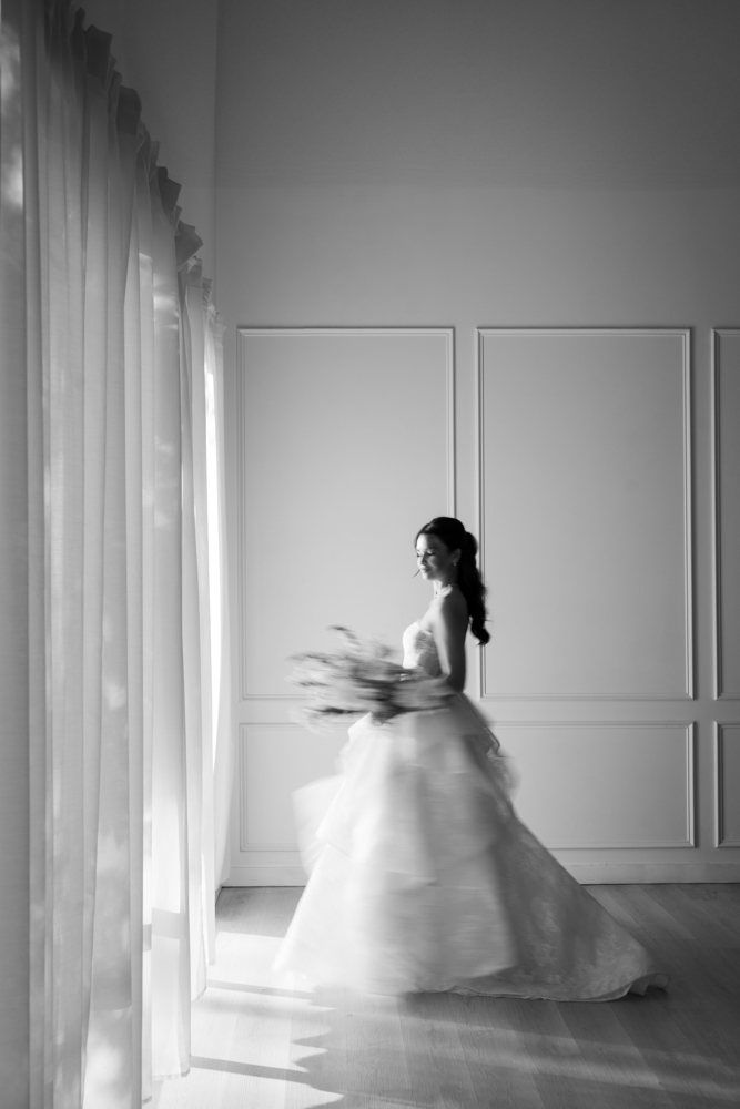 Full-length bridal portrait of Hannah, her gown pooling softly on the studio floor