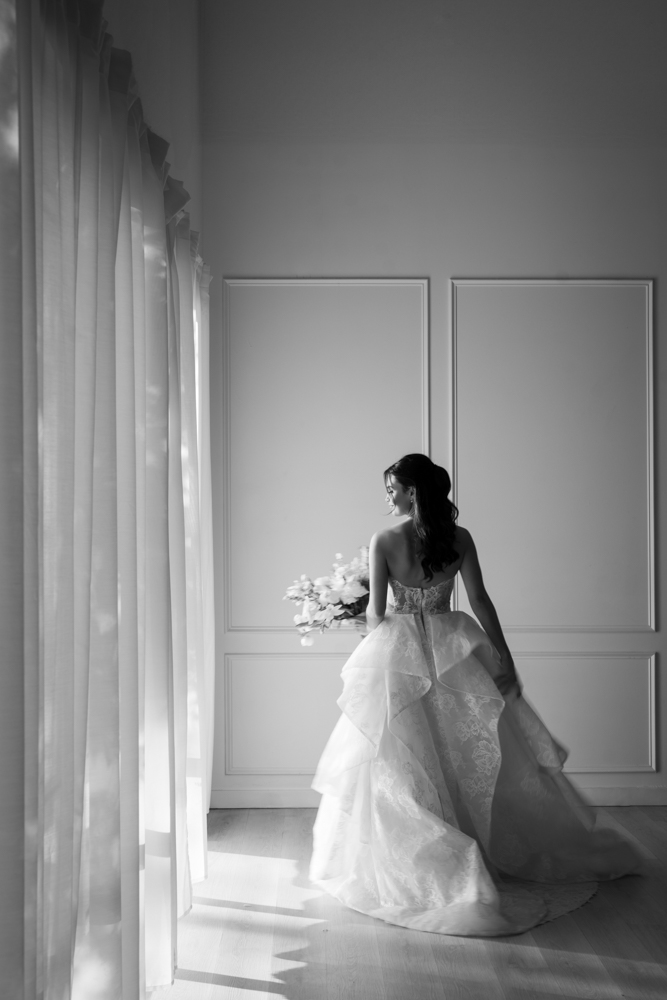 Hannah framed by the soft drapery archway custom-built for her bridal session