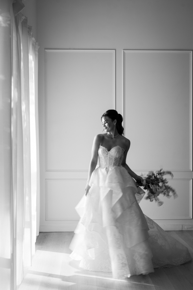 Close-up of the bodice and beadwork of Hannah's wedding gown in soft studio light