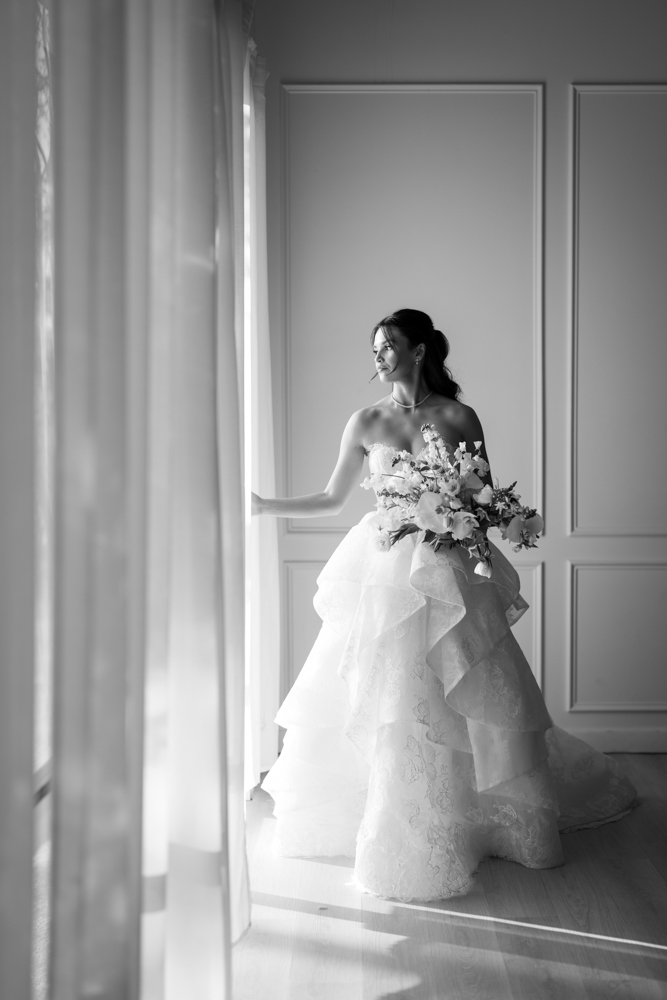 Hannah looking over her shoulder, the back of her gown catching the light