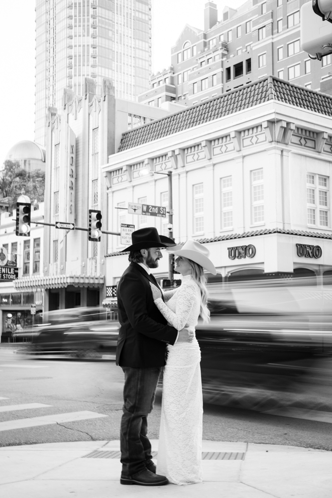 downtown fort worth engagement session with cowboy hats and architecture capturing the cowtown vibes of their love story by Tracy Autem Photographyx